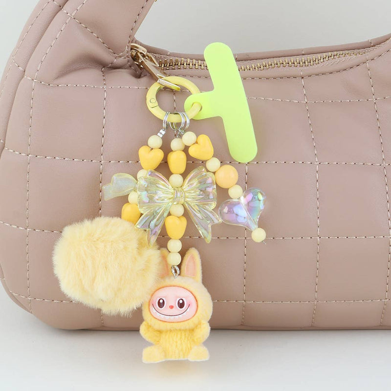 This is a Multi Ribbon Doll Beaded Bag Charm: YL | WILD FLIER GIFTS AND APPAREL