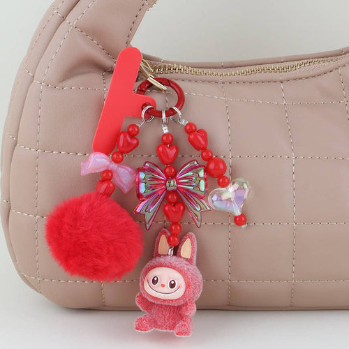 This is a Multi Ribbon Doll Beaded Bag Charm: YL | WILD FLIER GIFTS AND APPAREL
